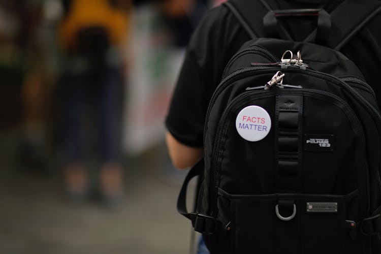 A rucksack with a 'facts matter' badge on it.