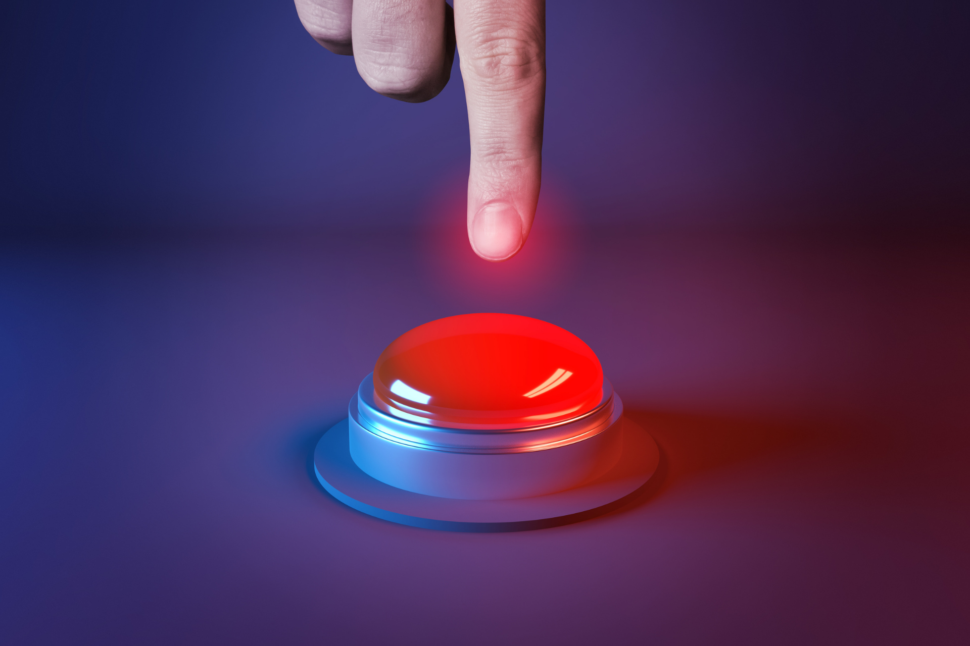 Index finger pressing a big red button
