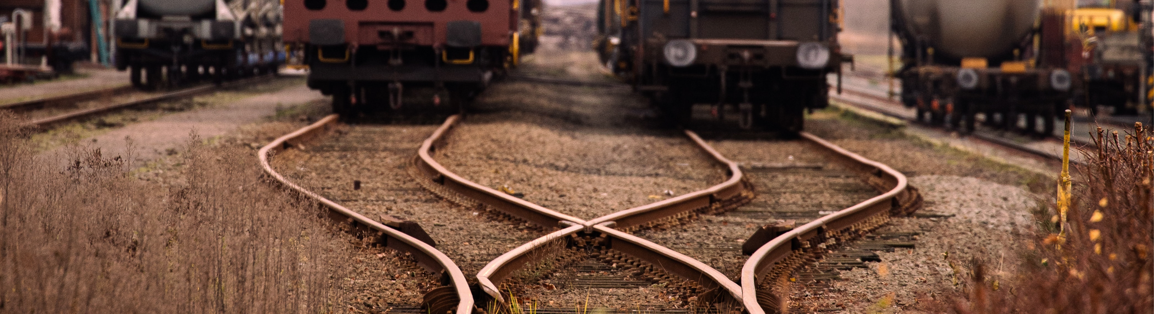 A photograph of a train track that diverges into two separate paths